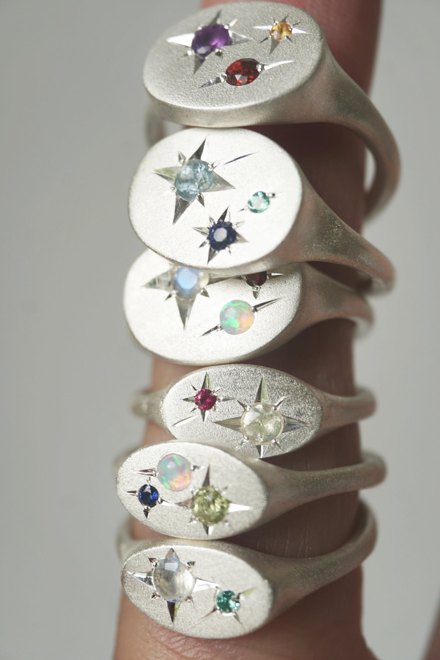 Handcrafted silver signet ring with up to four natural birthstones arranged like a constellation. The Orion Birthstone Signet Ring — personalised, handmade in the UK.