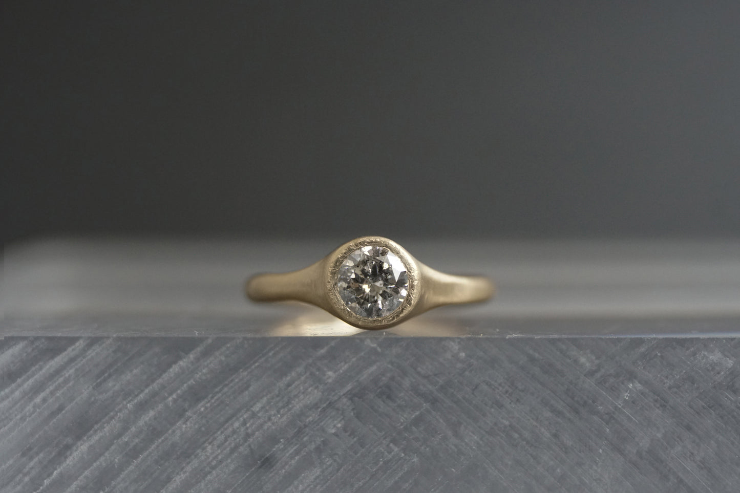 Handcrafted 14K yellow gold ring with a 0.5 ct salt and pepper diamond, showing the stone’s unique galaxy-like inclusions and matte wabi-sabi finish.