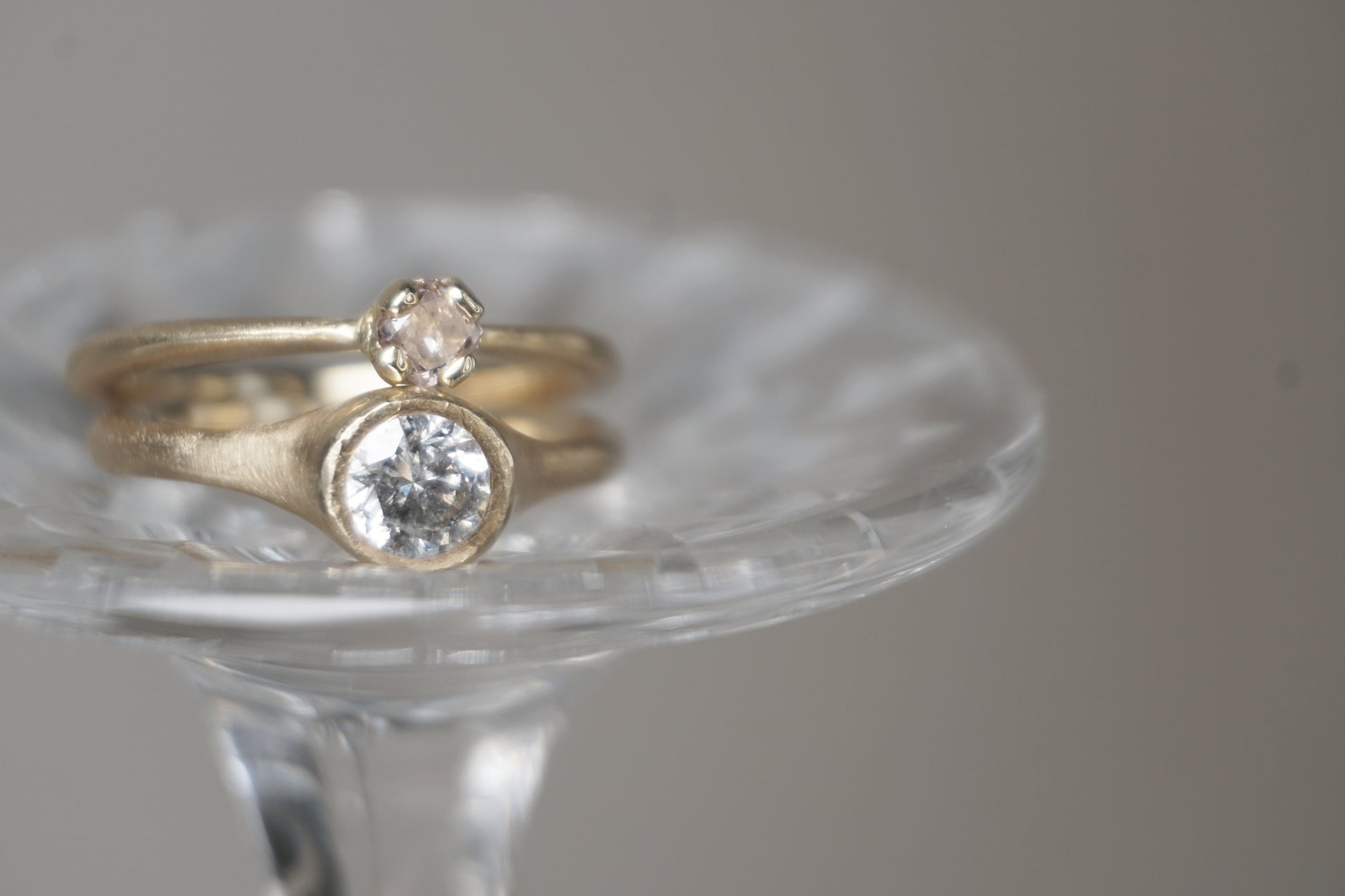Close-up view of natural salt and pepper diamond set in yellow gold, highlighting the stone’s speckled inclusions and soft polished surface.