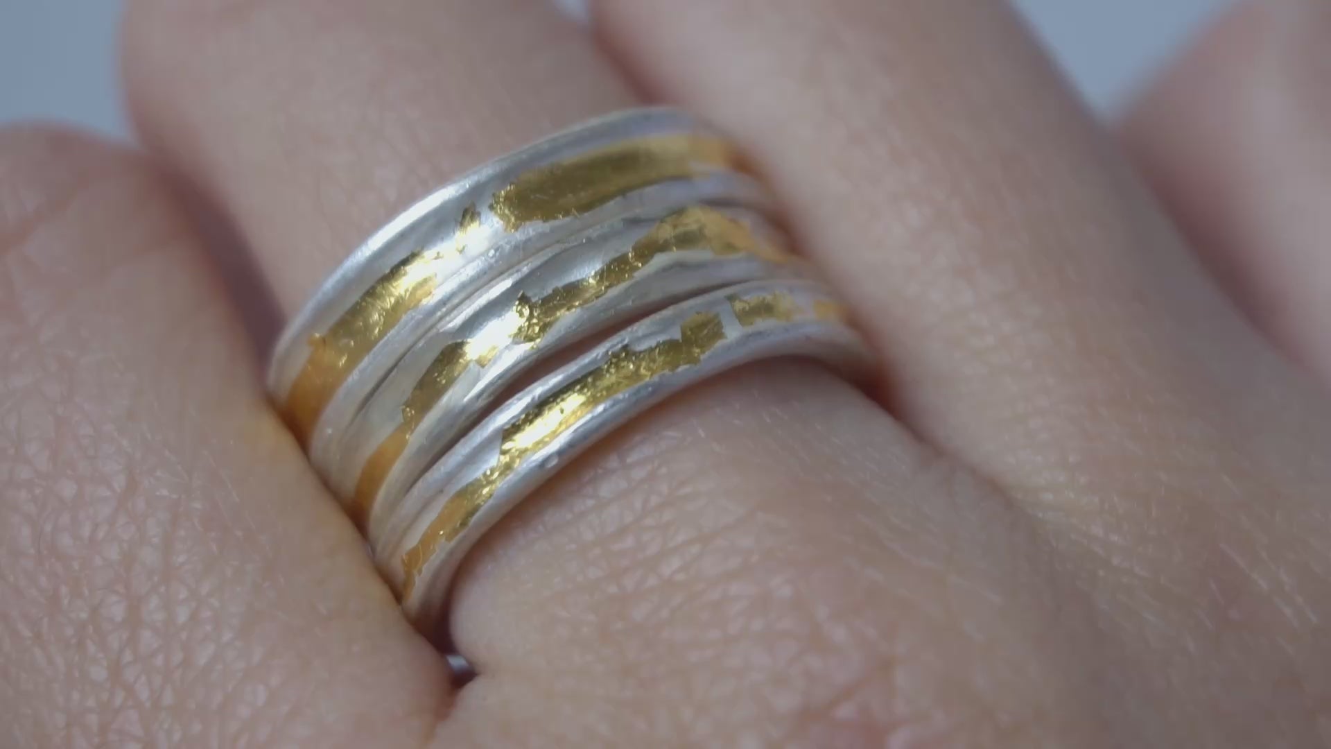 Two-tone gold and silver Keum-Boo ring worn on hand, minimalist and organic, ideal for stacking or as a wedding band.